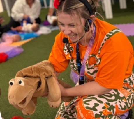 Coralie performing with a tortoise puppet
